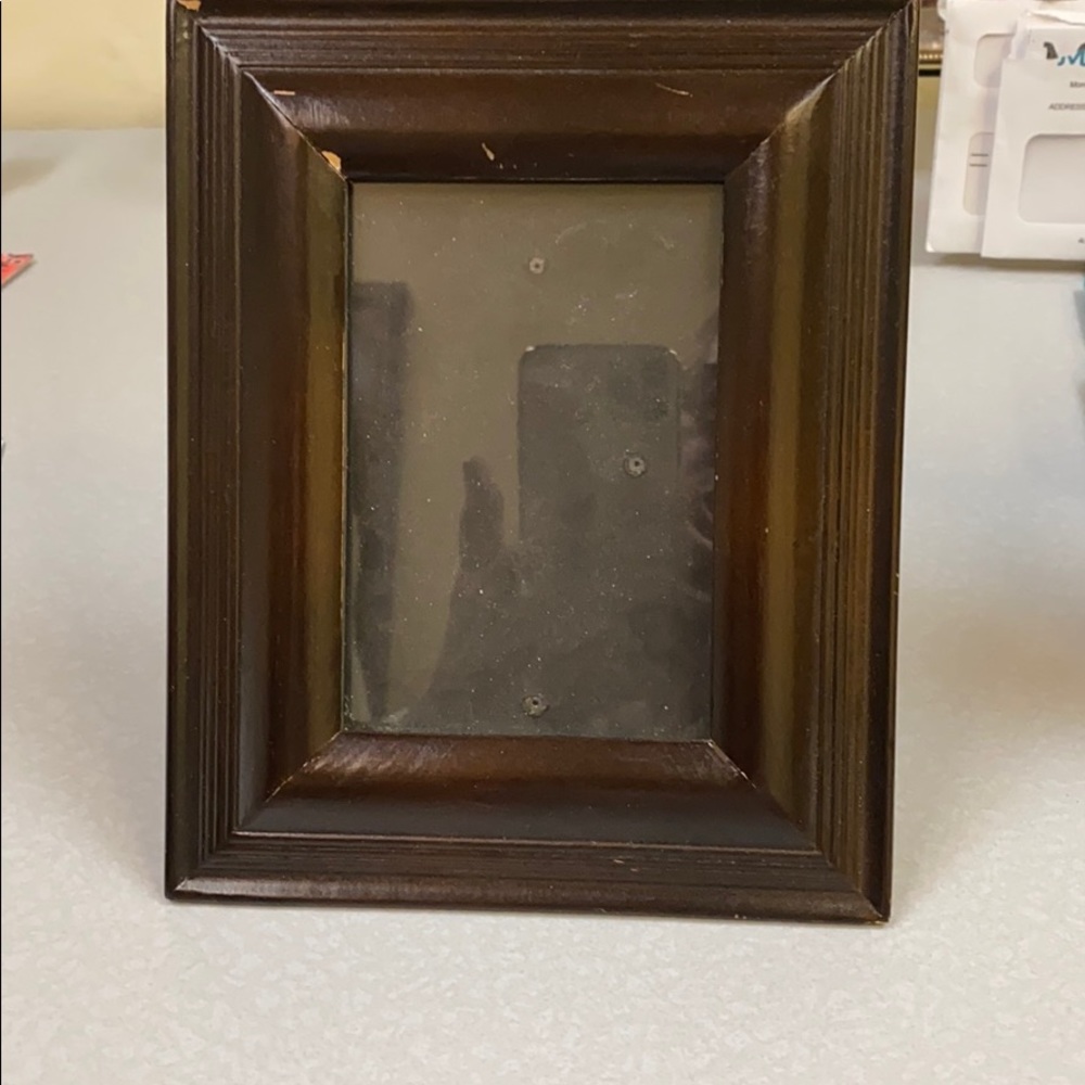 Wooden picture frame holds a 4X5” photo